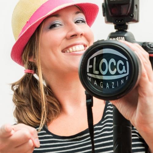 Andi Nicole Kuenneke smiling, holding a camera with a FLOCAL Magazine lens